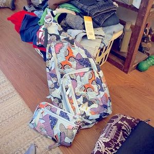 Vera Bradley sling backpack with matching wallet.